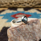 Silver dome shadowbox ring by Tricia Smith, featuring a handcrafted sterling silver dome with a dimensional shadowbox design and polished finish.  Side view.