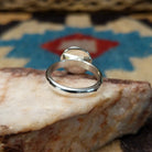 Silver dome shadowbox ring by Tricia Smith, featuring a handcrafted sterling silver dome with a dimensional shadowbox design and polished finish.  Underside view.