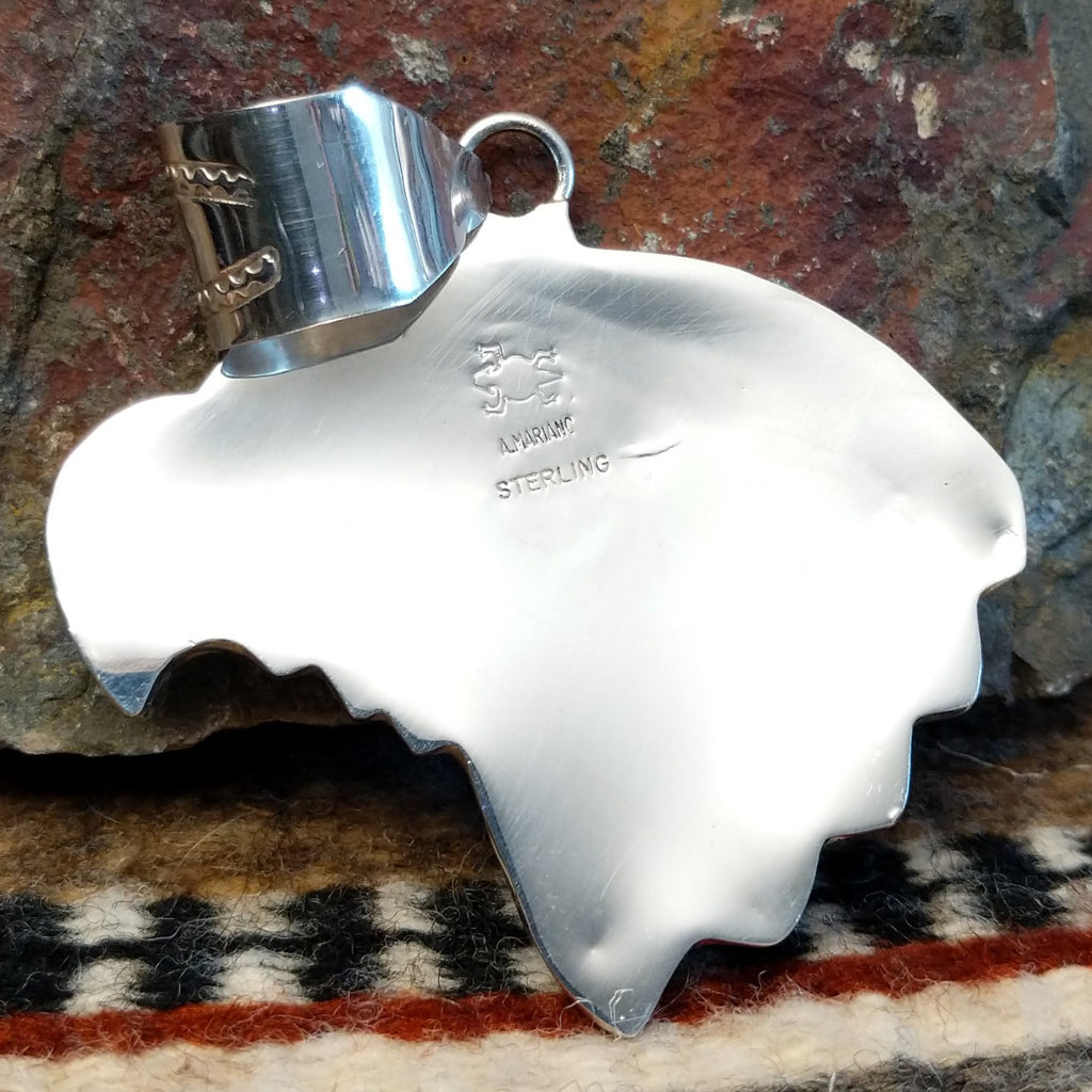 The back features the artisan's signature.