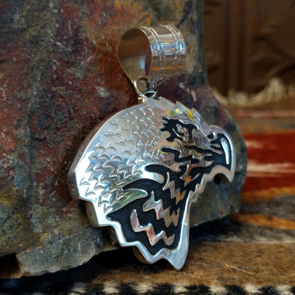 Sterling silver eagle head pendant and polished finish.