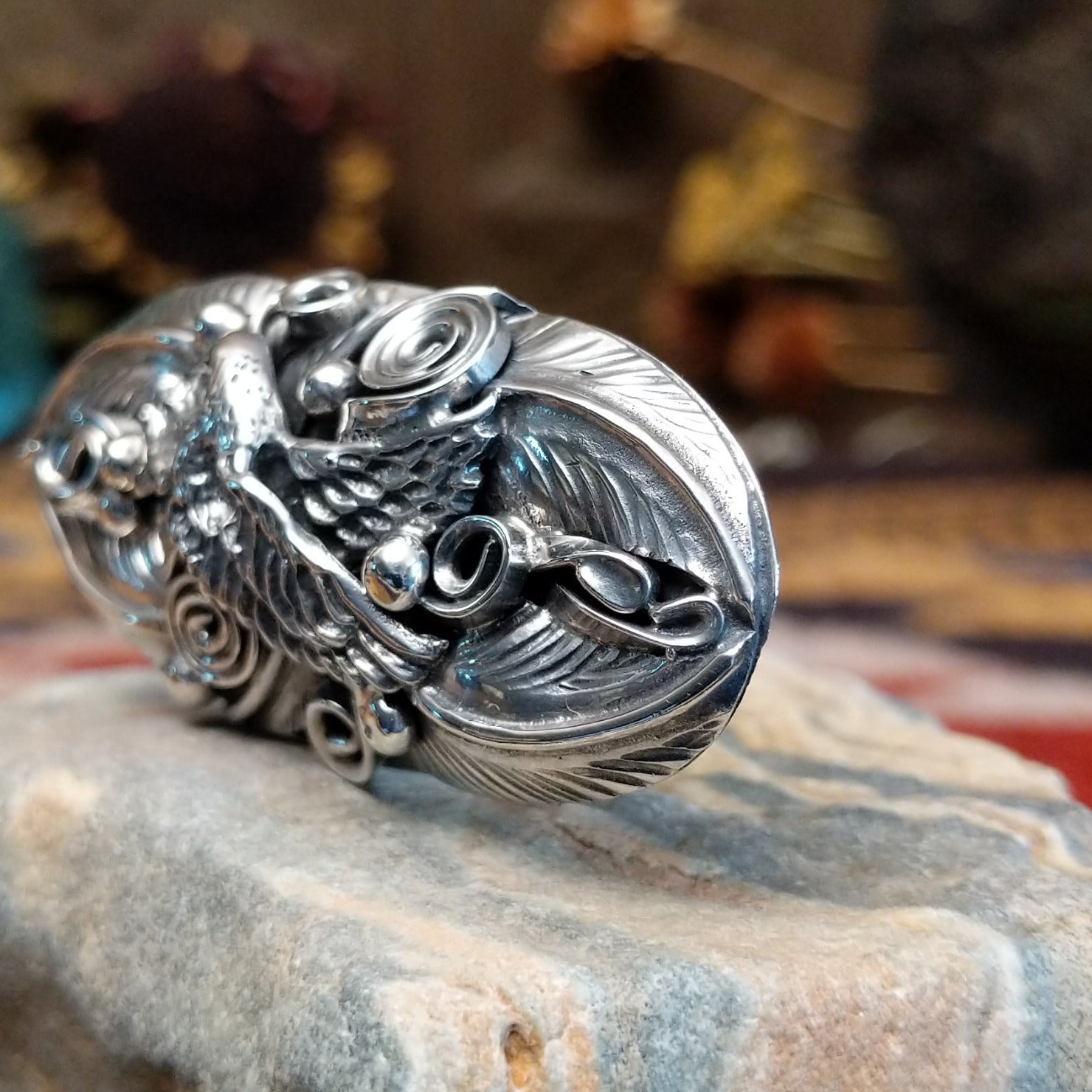 Handcrafted sterling silver ring by Navajo artist Allen Chee featuring a detailed eagle design in a traditional Southwestern Native American style.  Side view.