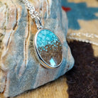 Silver-plated brass necklace with turquoise and San Pedro River sand set in the oval bezel.