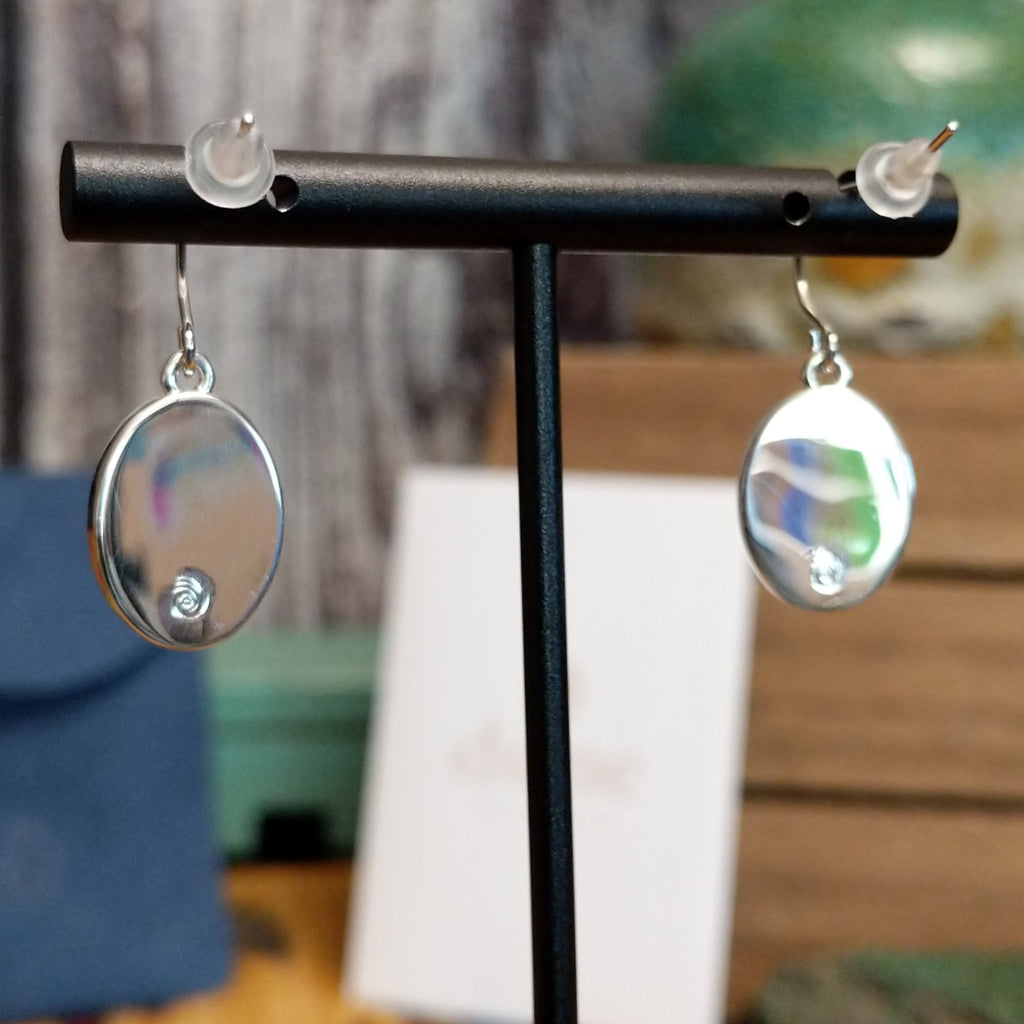 Dangle hooks and silver-plated brass with maker's trademark.