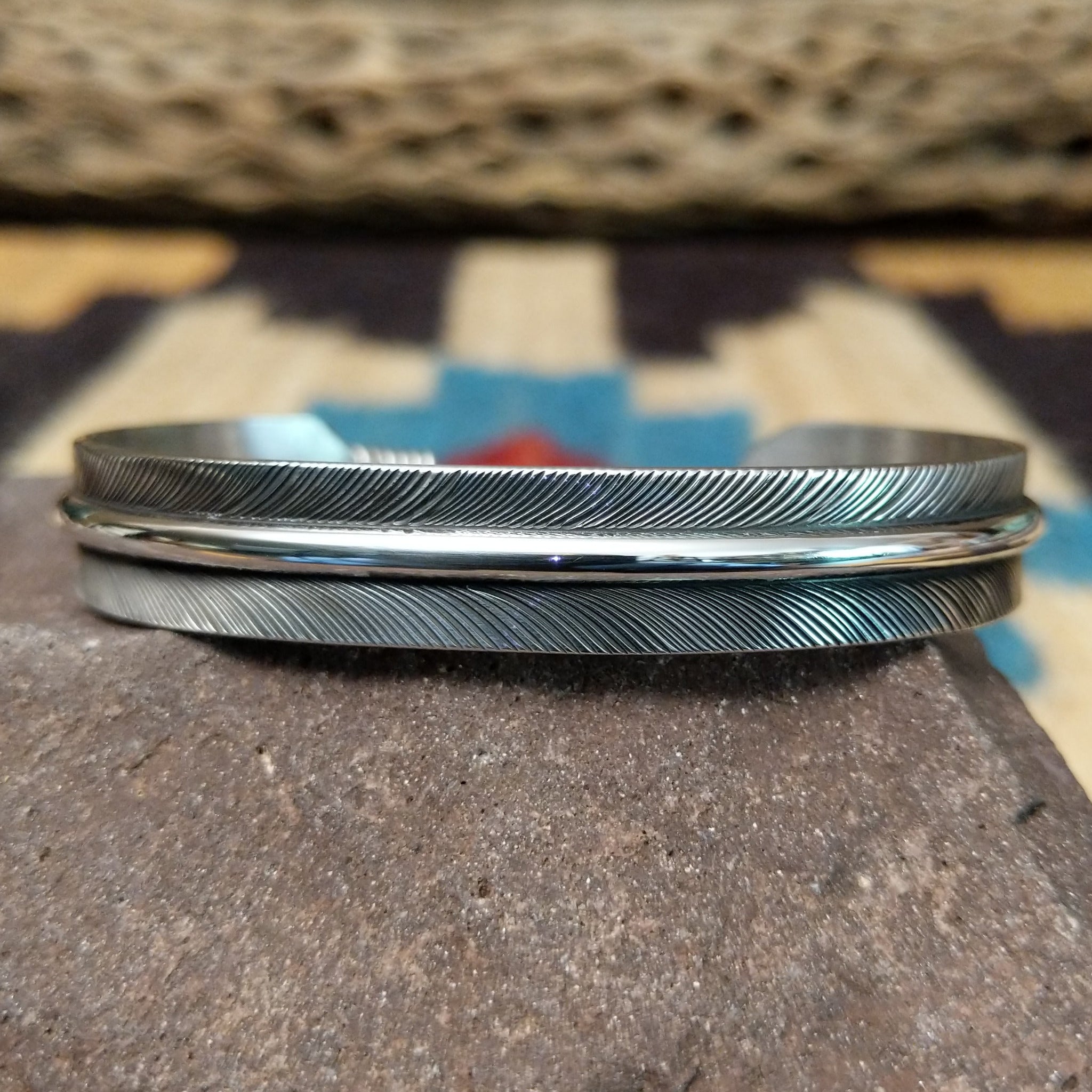 Silver feather cuff by Angela Martin, featuring a handcrafted sterling silver feather design with engraved details and traditional Southwestern craftsmanship.