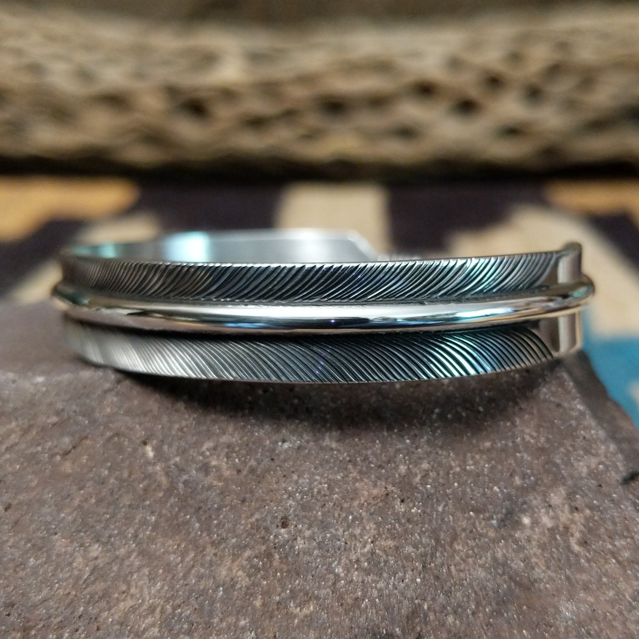 Silver feather cuff by Angela Martin, featuring a handcrafted sterling silver feather design with engraved details and traditional Southwestern craftsmanship.