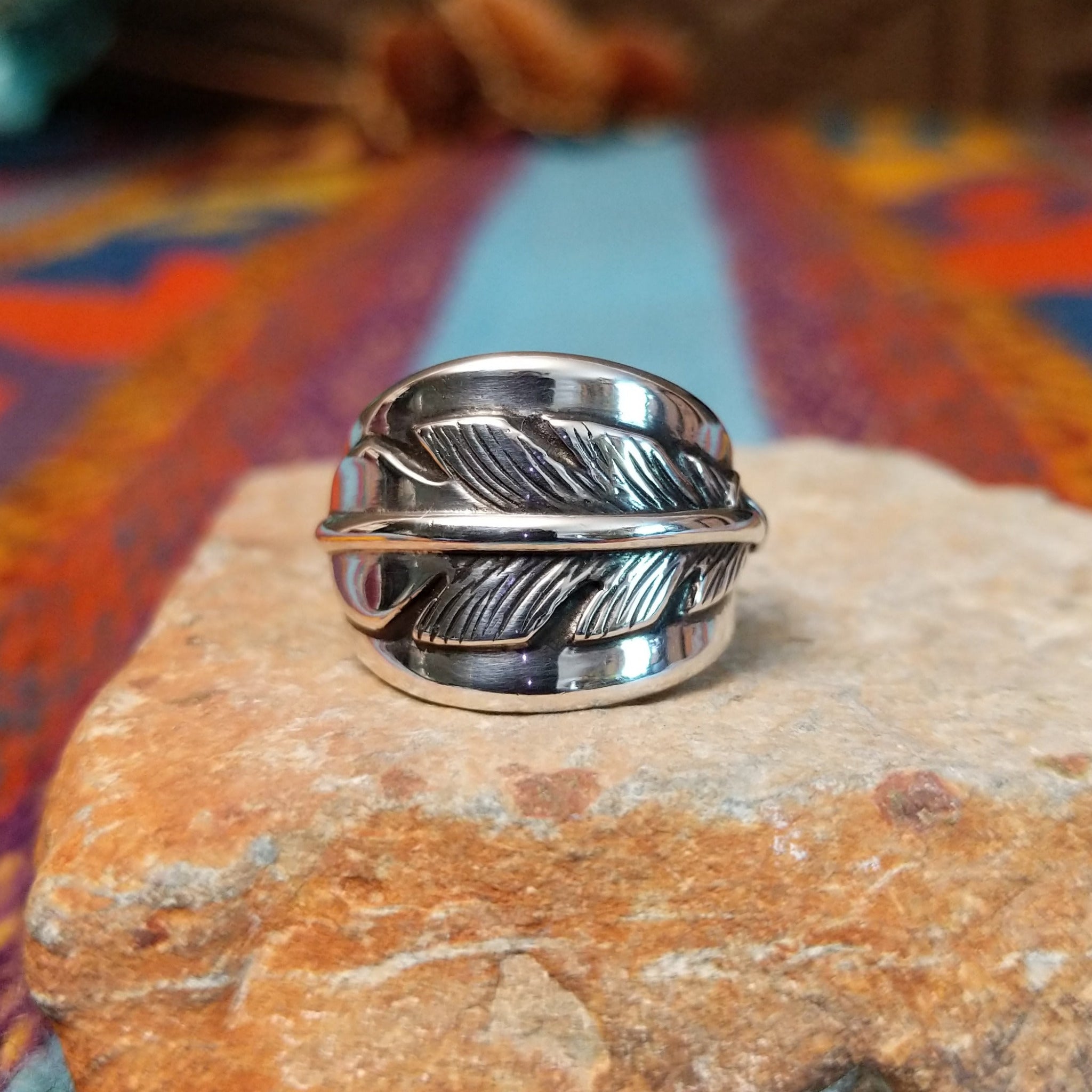 Sterling silver feather ring by L.P. with engraved feather and raised central shaft.