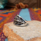 Sterling silver feather ring by L.P. with engraved feather and raised central shaft.