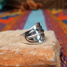 Sterling silver feather ring by L.P. with engraved feather and raised central shaft.
