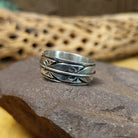 Silver feather ring by Raymond Coriz, featuring a detailed handcrafted feather design in polished sterling silver with traditional Southwestern-inspired craftsmanship.