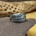 Silver feather ring by Raymond Coriz, featuring a detailed handcrafted feather design in polished sterling silver with traditional Southwestern-inspired craftsmanship.