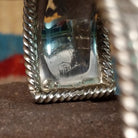 Silver filigree cuff by Larry Joe, featuring hand-engraved scrollwork framed by twisted rope borders on a handcrafted wide sterling silver open cuff.  Artisan stamp.