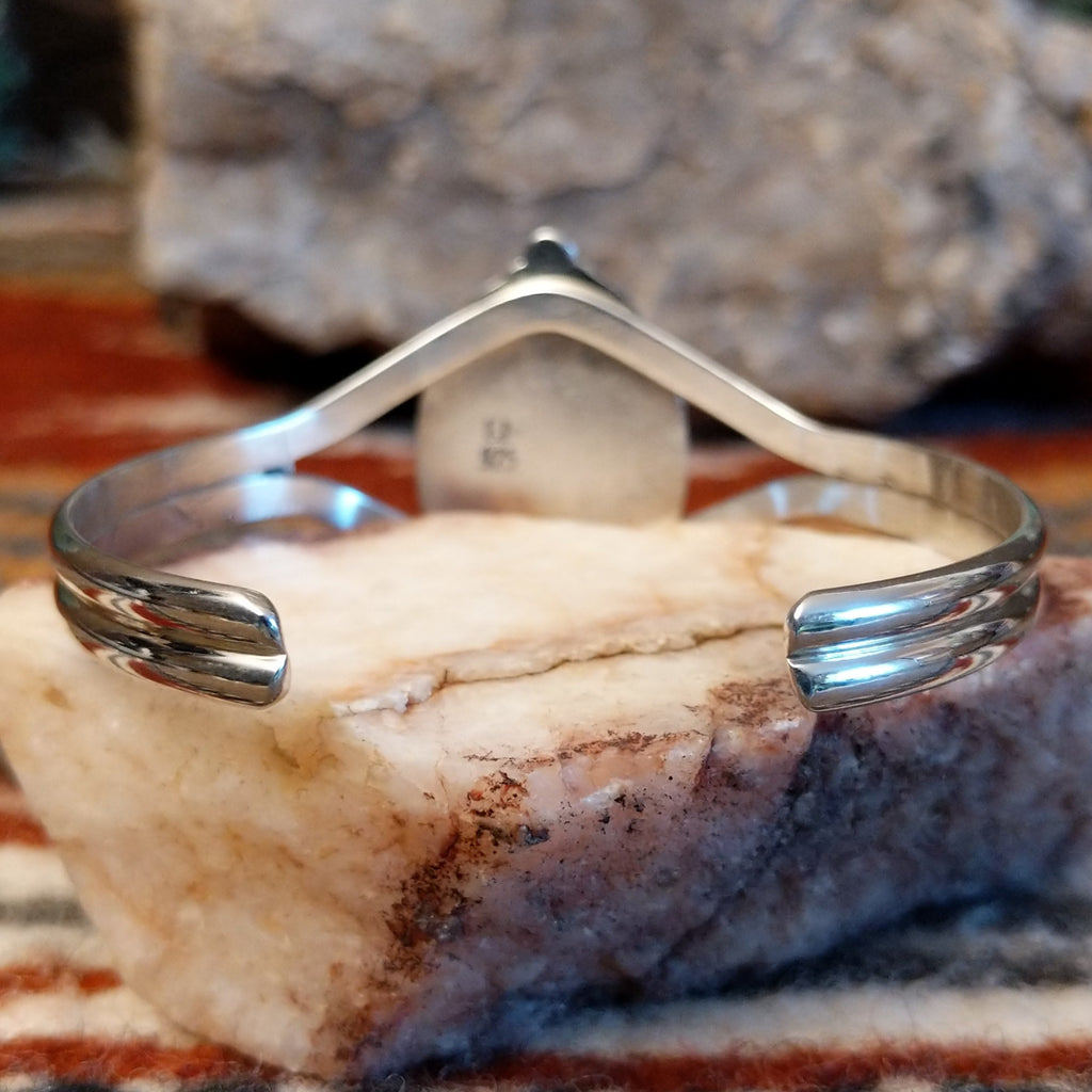 The back features the polished band.