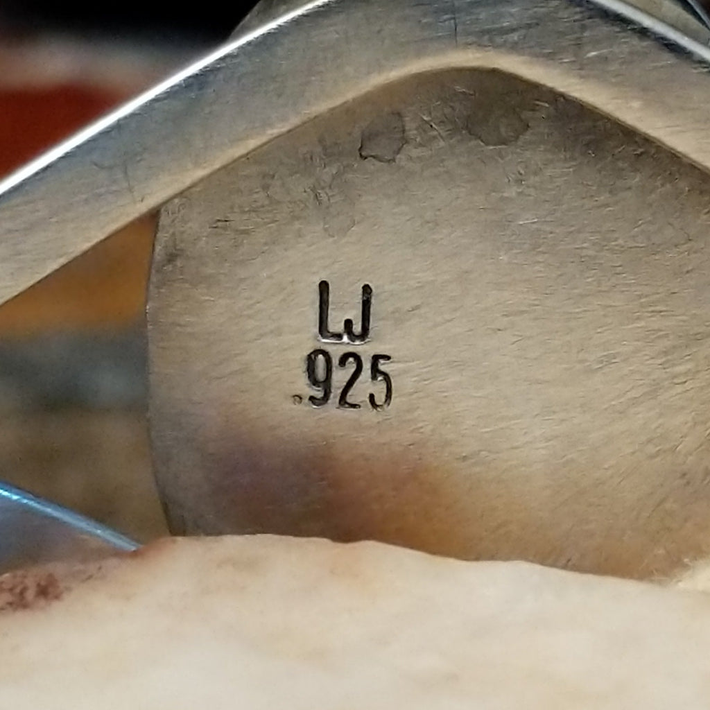 Close-up of the artisan's stamped initials.