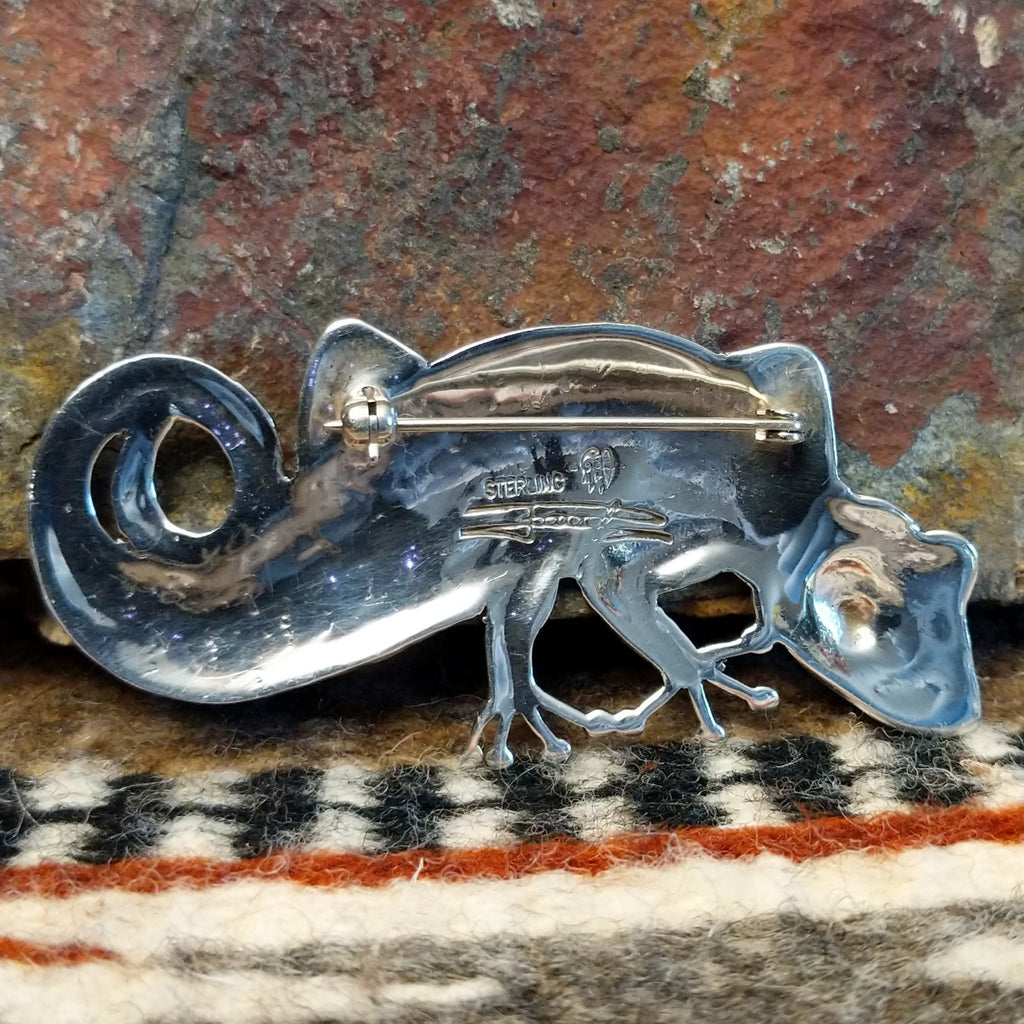 The back features the artisan's initials.