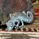 Sterling silver gecko pin with intricate stamped detailing.