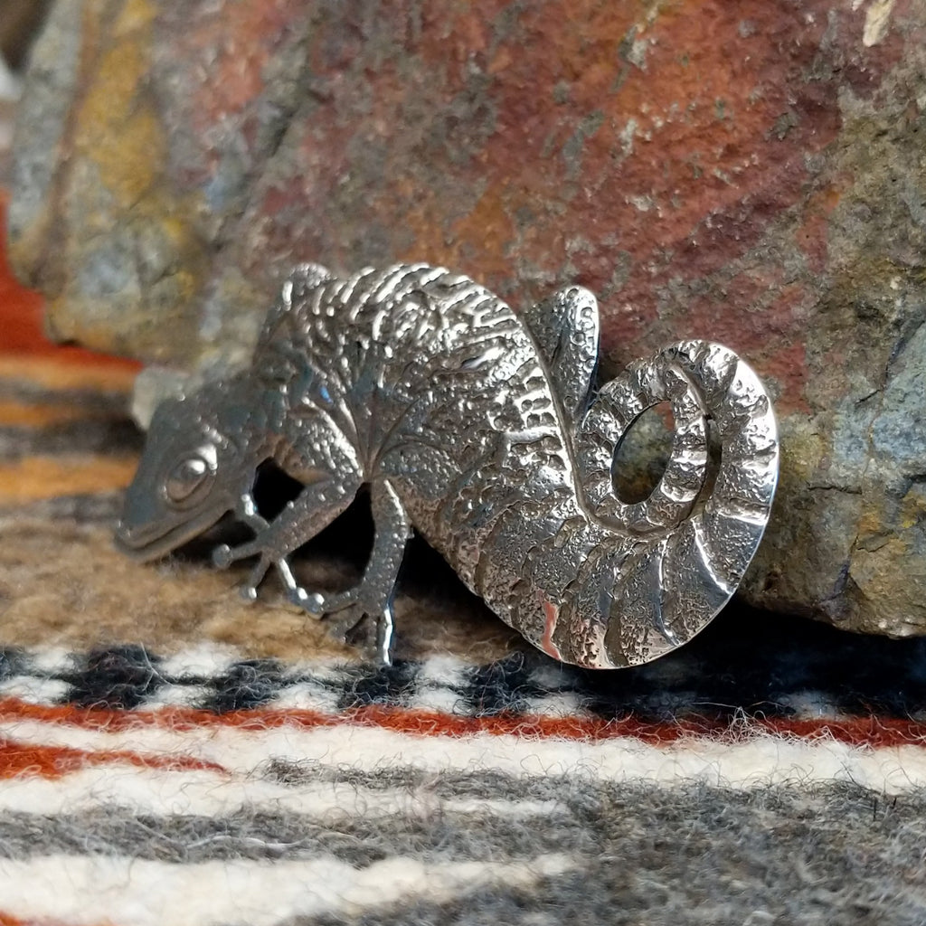 Sterling silver gecko pin with intricate stamped detailing.