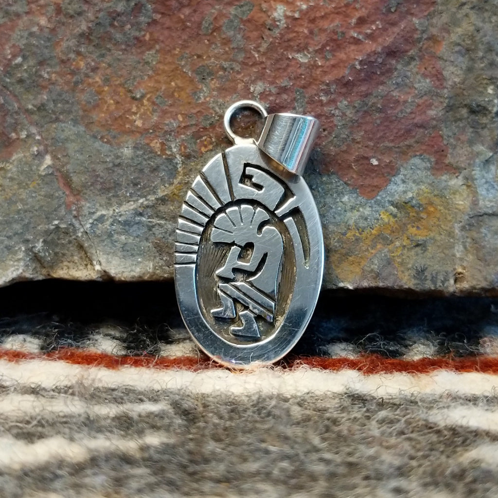 Small oval sterling silver pendant with Kokopelli design.