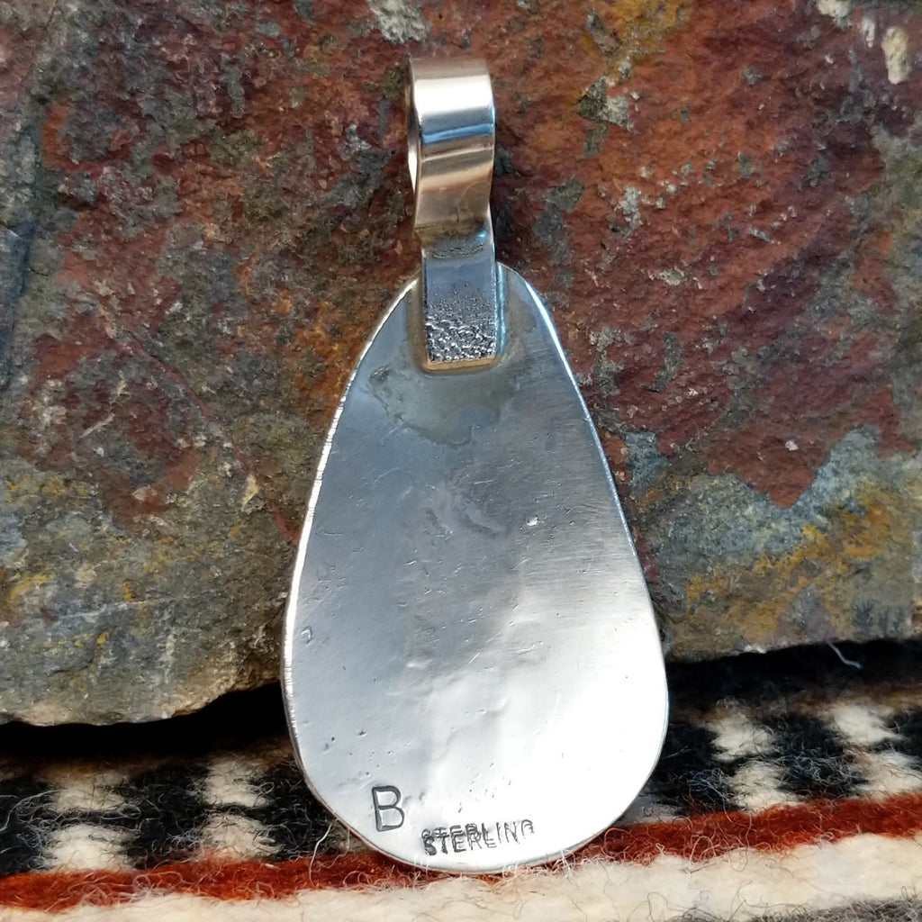 The back features the artisan's stamp.