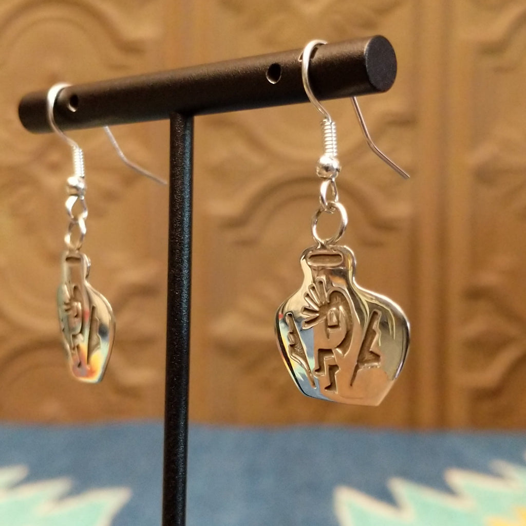 Sterling silver dangle earrings shaped into pots with kokopelli designs on the surface.