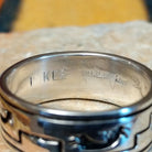 Silver Kokopelli Ring by Irene Kee featuring a wide polished silver band with a flute-playing Kokopelli figure, geometric Southwestern patterns, oxidized detailing, and smooth silver edges; artisan and Sterling Silver stamp.