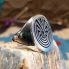 Sterling silver ring with man in the maze motif.