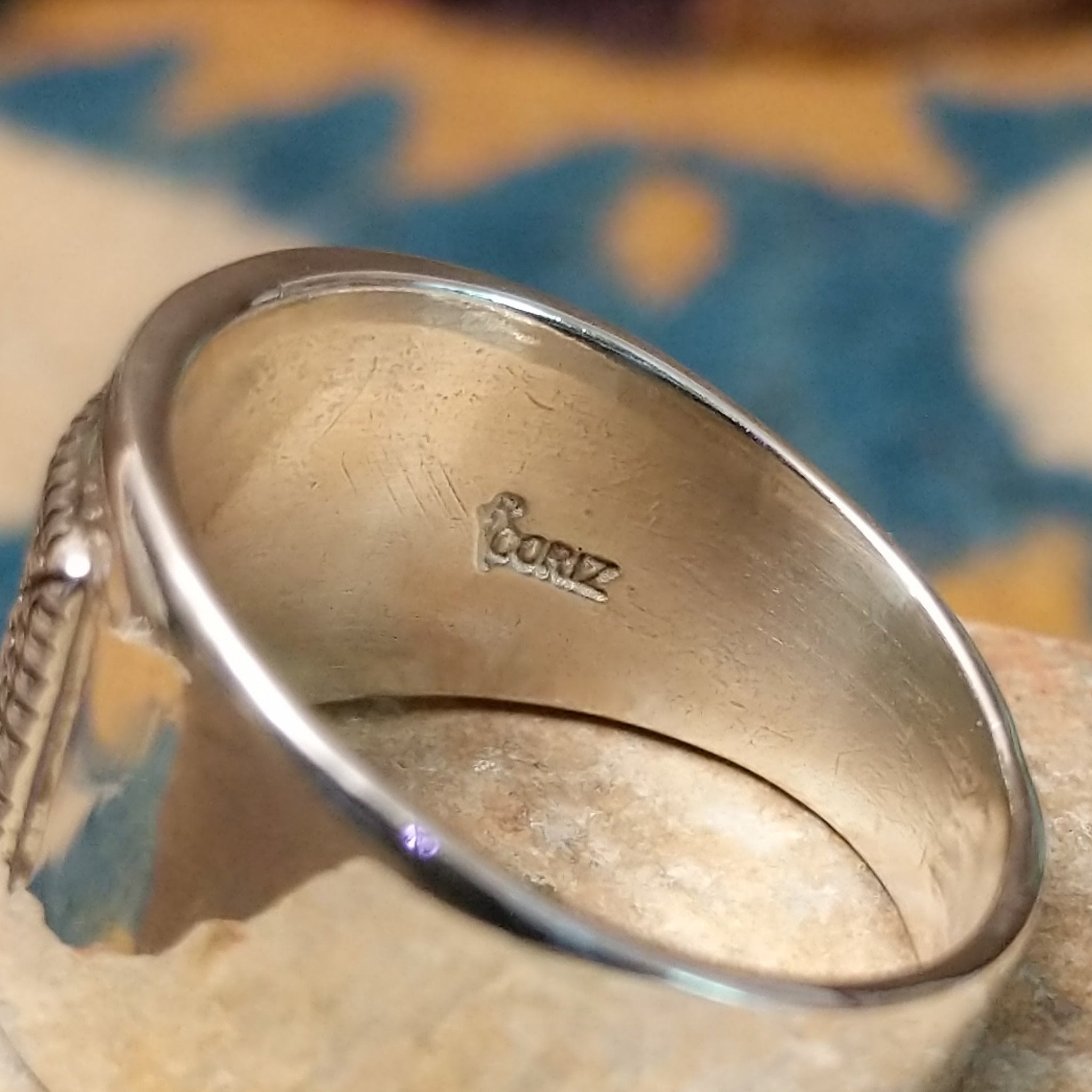 Sterling silver ring by Raymond Coriz with a rectangular hand-stamped geometric design; artisan stamp.