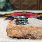 Silver spinner ring by Elaine Becenti with stamped geometric designs and layered movable bands.