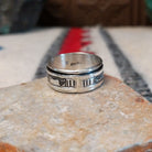 Silver spinner ring by Elaine Becenti with stamped rotating outer band.