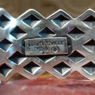 Close-up of the artisan's stamped signature.