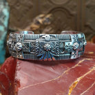 Sterling silver cuff with stamping and thunderbird motif.