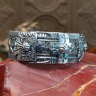 Sterling silver cuff with stamping and thunderbird motif.