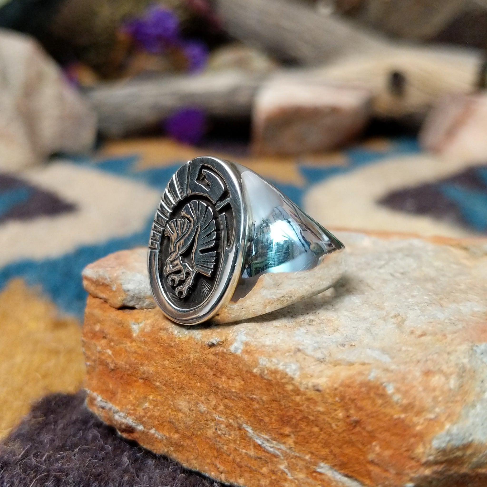 Sterling silver Thunderbird ring by Calvin Peterson with hand-stamped Southwestern detailing; side view.