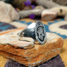 Sterling silver Thunderbird ring by Calvin Peterson with hand-stamped Southwestern detailing; side view.