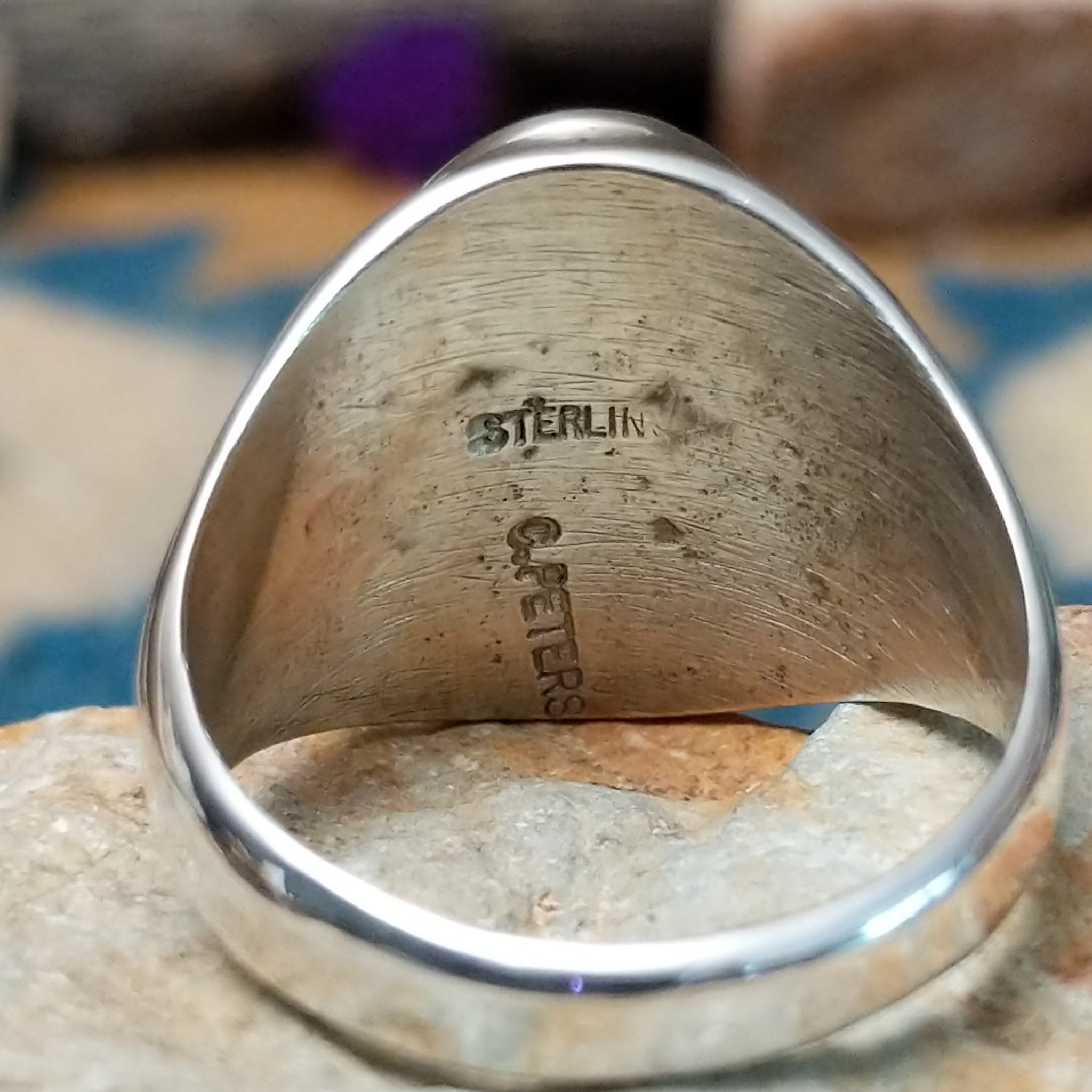 Sterling silver Thunderbird ring by Calvin Peterson with hand-stamped Southwestern detailing; artisan and Sterling Silver stamp.