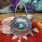 Sterling silver Arnold Blackgoat key hook with concho-style floral design and centered turquoise stone.