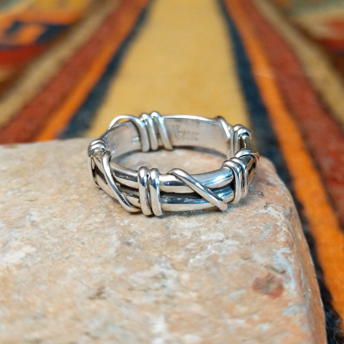 Silver Wire Ring by Raymond Coriz featuring layered sterling silver bands with curved wire wraps, decorative coils, and a polished finish in a Native American Southwestern design.