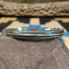 Slender silver feather cuff by Lena Platero, featuring a finely engraved sterling silver feather design in a handcrafted slim open cuff with polished finish.