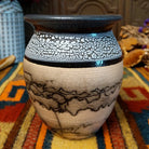 This distinctive Small Horsehair Pottery by Roger Calhoun features a tapered ceramic vessel with natural earth tones, black horsehair patterns, a decorative black-and-white crackled upper section, and a wide black rim.