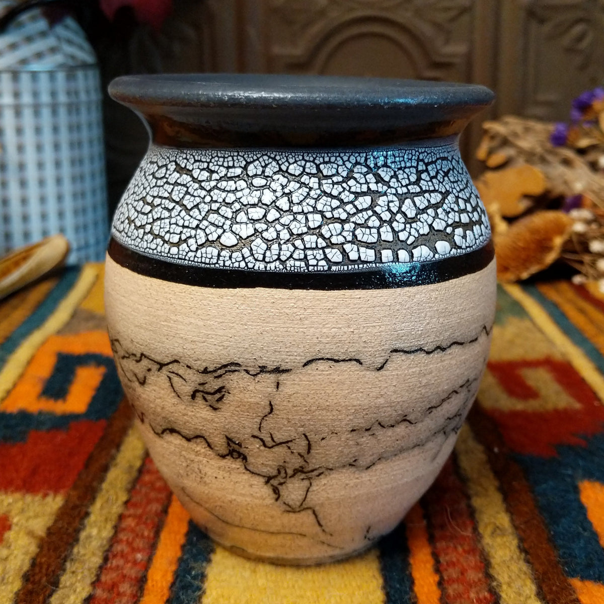 This distinctive Small Horsehair Pottery by Roger Calhoun features a tapered ceramic vessel with natural earth tones, black horsehair patterns, a decorative black-and-white crackled upper section, and a wide black rim.