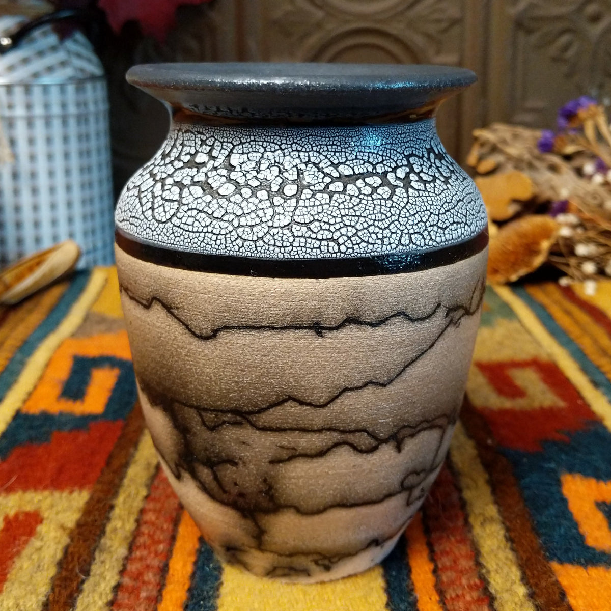 This distinctive Small Horsehair Pottery by Roger Calhoun features a tapered ceramic vessel with natural earth tones, black horsehair patterns, a decorative black-and-white crackled upper section, and a wide black rim.