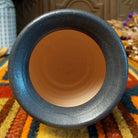 This distinctive Small Horsehair Pottery by Roger Calhoun features a tapered ceramic vessel with natural earth tones, black horsehair patterns, a decorative black-and-white crackled upper section, and a wide black rim; top view.