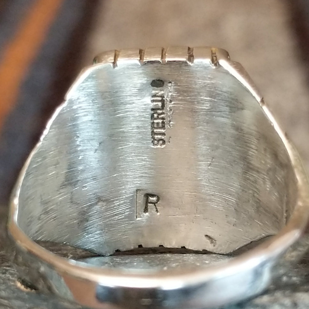 The authentication and artist's signature is found on the inside of the ring.
