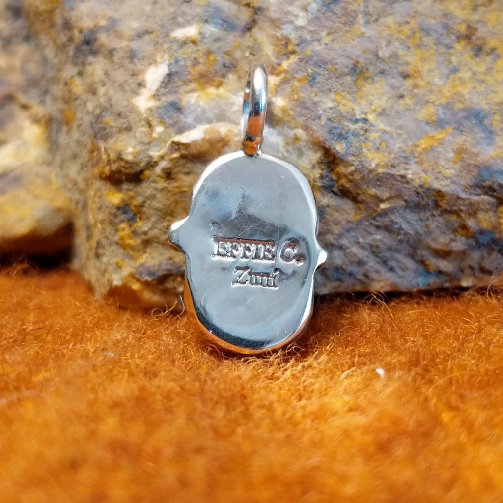 The back features the artisan's stamped signature.