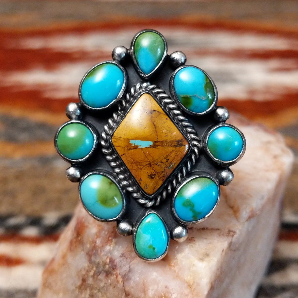 Diamond shaped sterling silver ring with Sonoran gold cabochons and twisted rope centerpiece with boulder turquoise.
