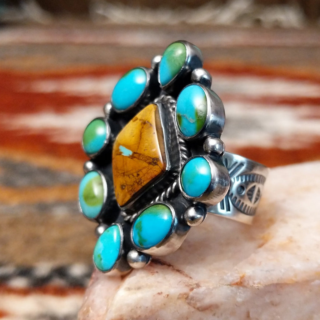 Diamond shaped sterling silver ring with Sonoran gold cabochons and twisted rope centerpiece with boulder turquoise.