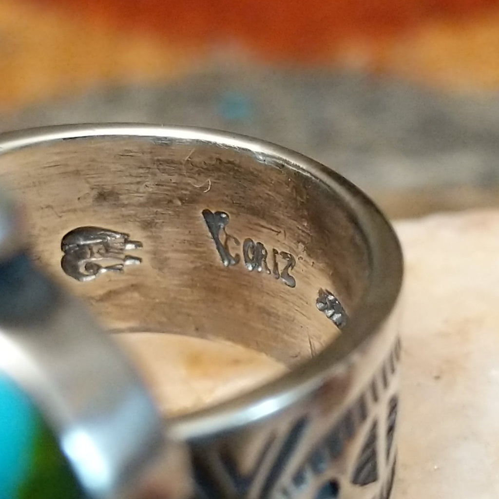 The artisan's stamped signature is found on the underside of the band.