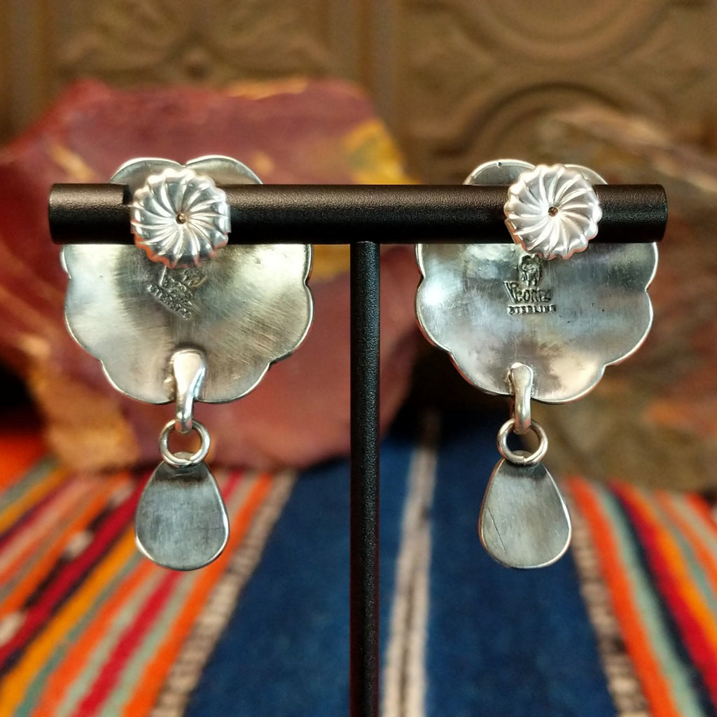 The back of the concho earrings feature the artisan's stamped signature.
