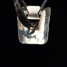 Artisan and Sterling Silver stamp on back of Bolo Tie.