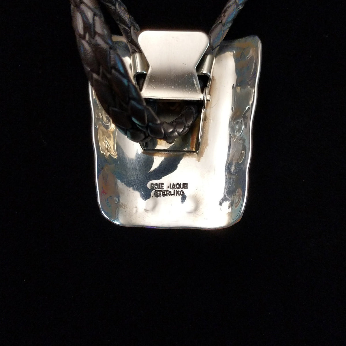 Artisan and Sterling Silver stamp on back of Bolo Tie.