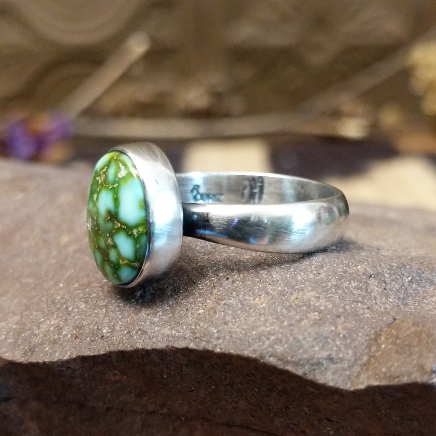 Sterling silver ring with Sonoran gold turquoise set in a round bezel.